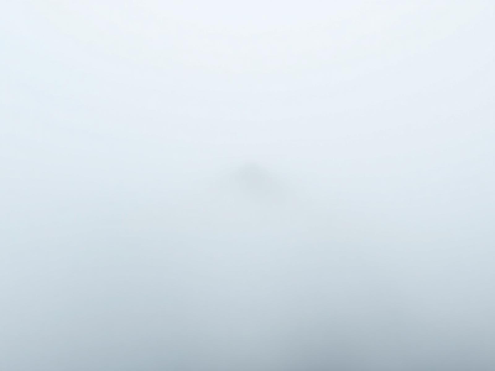 A ridgeline emerging through fog